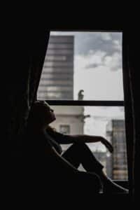 Young adult reflecting on life transitions with support from therapists in NYC.