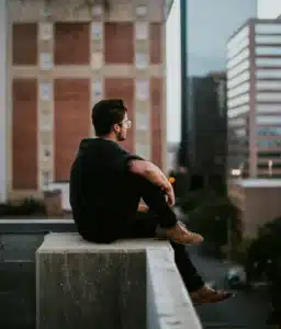 Man reflecting on NYC rooftop about starting psychodynamic therapy for high-functioning adults in the city