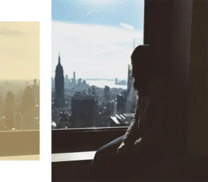 Woman overlooking NYC skyline seeking psychodynamic therapy for high-functioning adults to find inner clarity