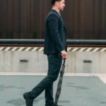 A woman rests her head on a desk beside an open laptop and glasses, eyes closed, showing mental fatigue after long work hours