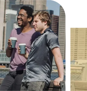 An Asian man sits on a bench reviewing a book and a calendar, focused and overwhelmed, with trees and open space behind him