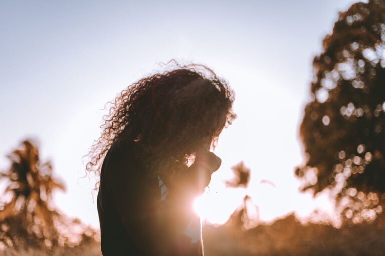 Silhouette of a person reflecting outdoors, representing the emotional impact of depression therapy
