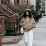 African American woman walking down a city street, gentle smile capturing calm movement and presence
