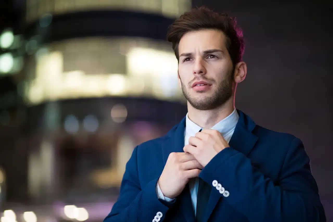Man adjusting jacket symbolizing improved self worth and confidence through self esteem therapy