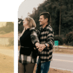  African man in professional clothing stands outdoors against a New York City skyline, appearing thoughtful and composed