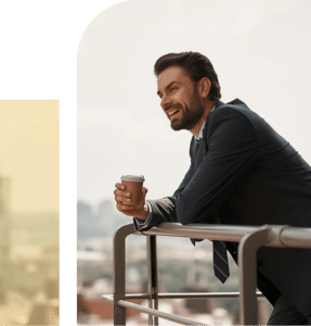 Man smiling with coffee in hand, reflecting ease, presence, and emotional steadiness in everyday life.