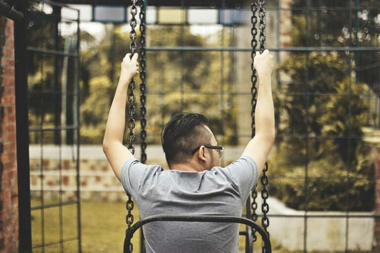 Man sitting on a swing outdoors
